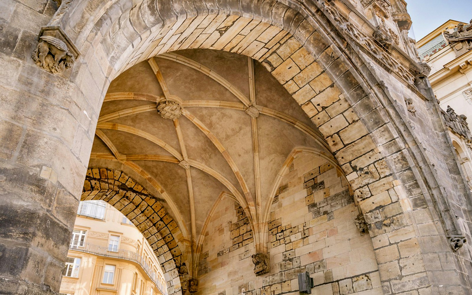 Exterior archway of Powder Tower in Prague with detailed stonework.