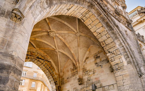 Exterior archway of Powder Tower in Prague with detailed stonework.