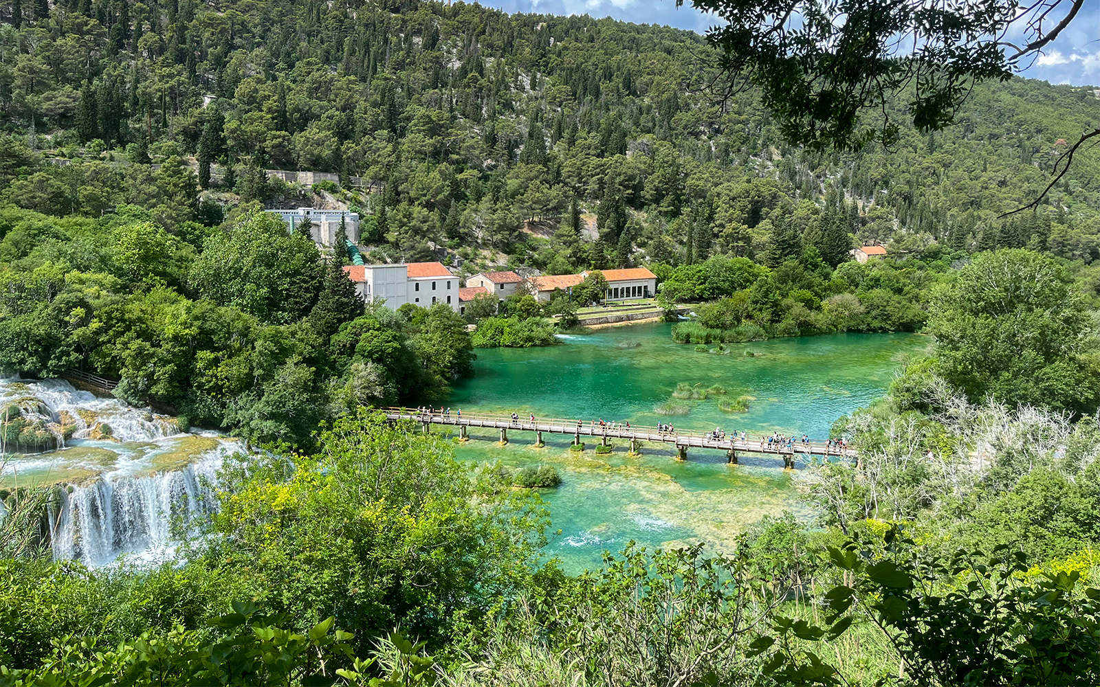Krka bridge spanning over lush greenery and river at Krka National Park, Croatia.