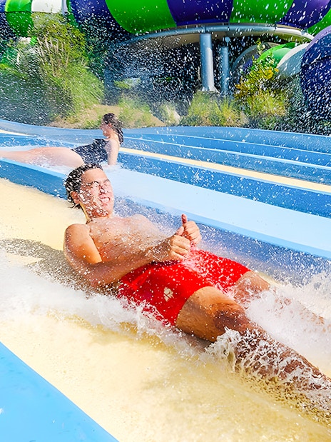 People enjoying the Pistas Blandas water slide at Aquopolis.
