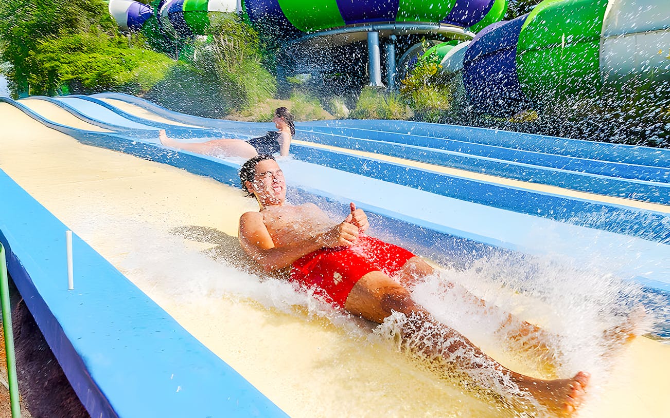 People enjoying the Pistas Blandas water slide at Aquopolis.