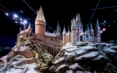 Hogwarts castle model covered in snow, showcasing Christmas at Hogwarts.