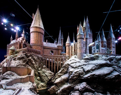 Hogwarts castle model covered in snow, showcasing Christmas at Hogwarts.
