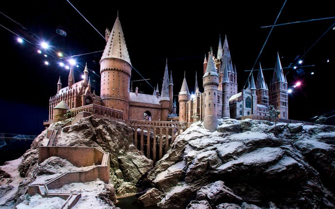 Hogwarts castle model covered in snow, showcasing Christmas at Hogwarts.