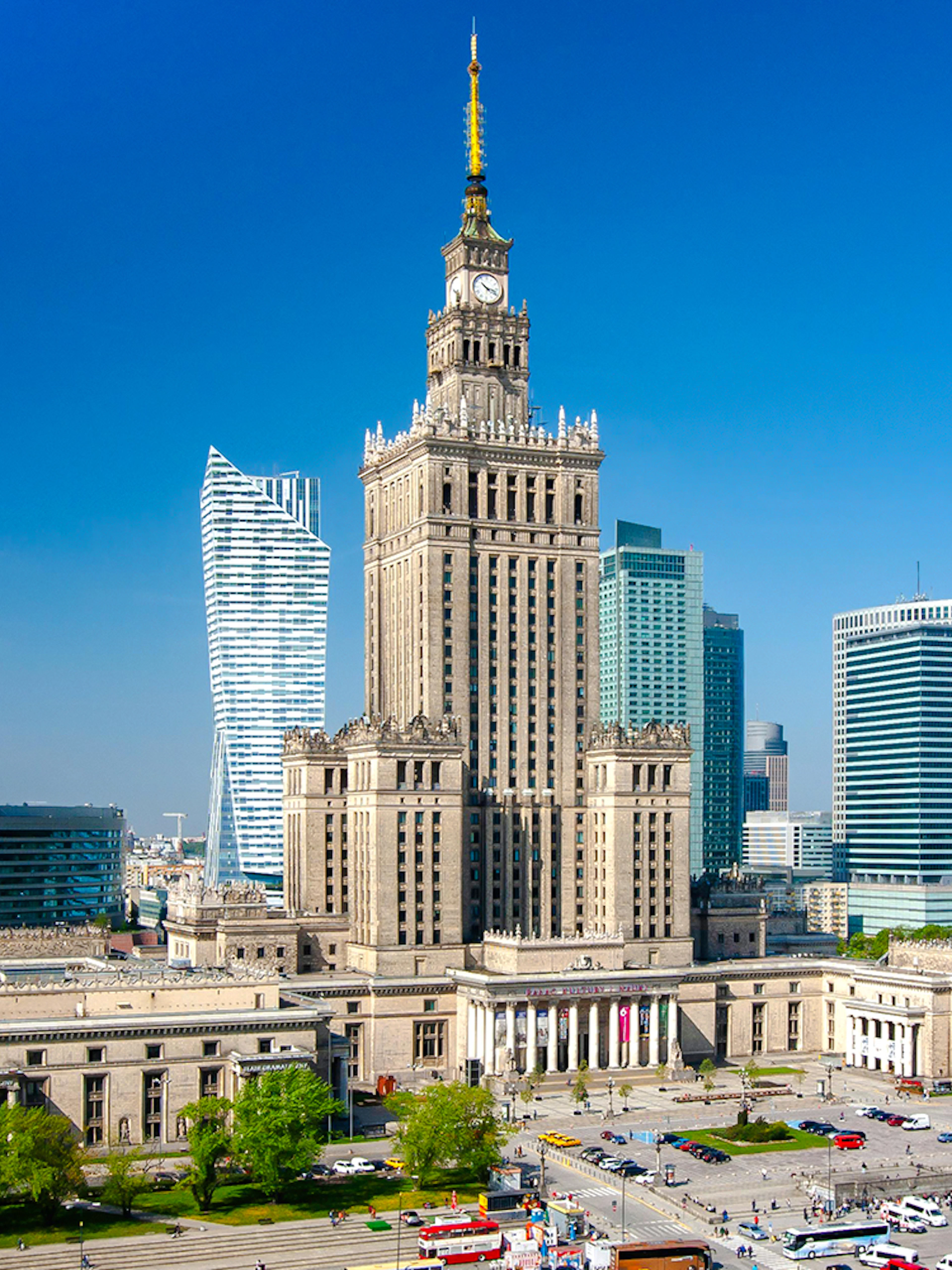 Palace of Culture and Science in Warsaw, Poland, surrounded by modern skyscrapers.
