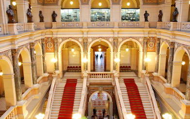 Grand staircase and ornate arches inside the National Prague Museum.