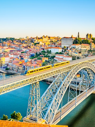 Train crossing Dom Luís I Bridge over Douro River in Porto, Portugal.