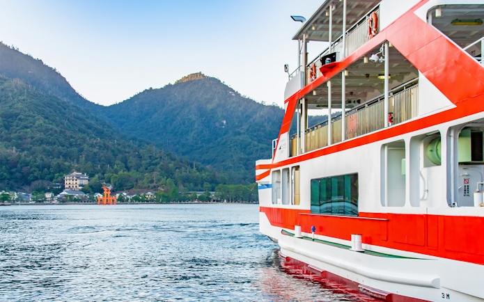 Ferry approaching Miyajima Island with view of Itsukushima Shrine's torii gate, Hiroshima.