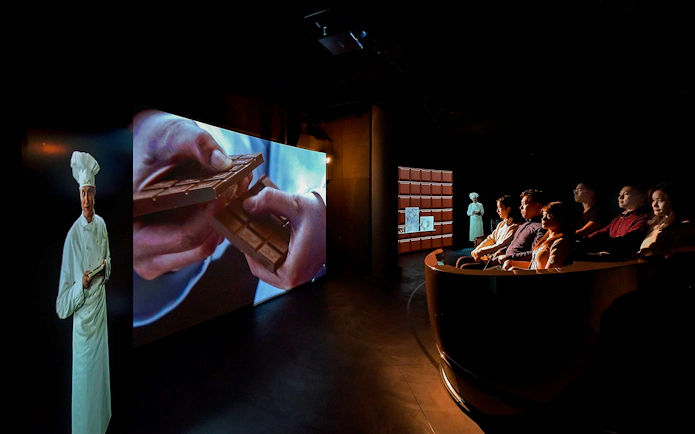 Visitors watching chocolate-making presentation at Swiss Chocolate Adventure, Museum of Transport, Lucerne.