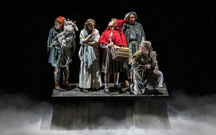 Actors in costume on stage during "Into The Woods" production.