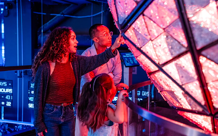 Visitors exploring the Times Square Ball exhibit at One Times Square.