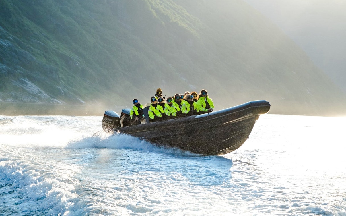 RIB boat with passengers on Geiranger Fjord safari.