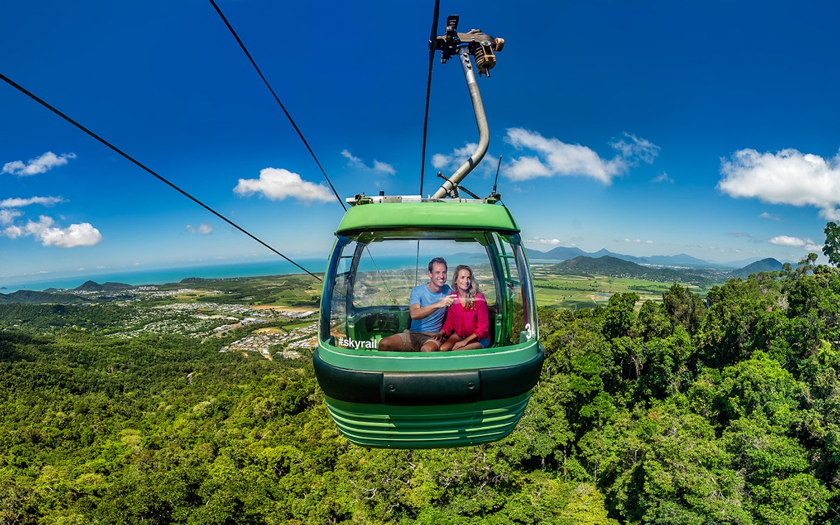 People enjoying the view from a cable car on the Kuranda Skyrail Rainforest Cableway.
