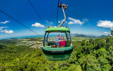 People enjoying the view from a cable car on the Kuranda Skyrail Rainforest Cableway.
