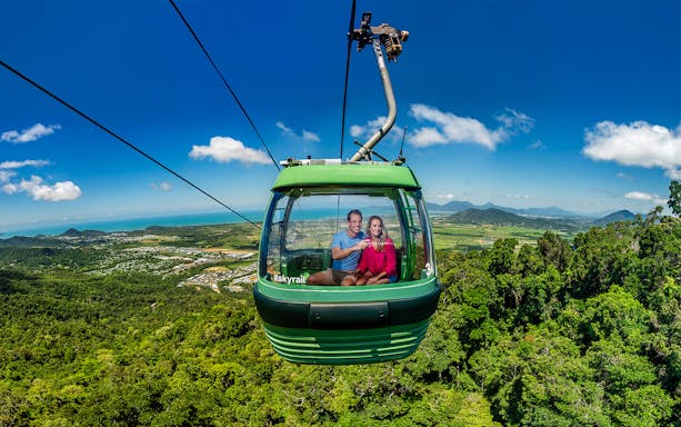 People enjoying the view from a cable car on the Kuranda Skyrail Rainforest Cableway.