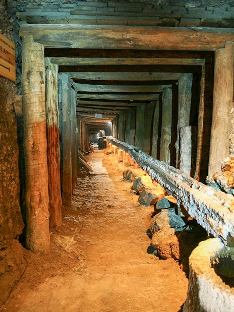 Wieliczka Salt Mine tunnel with wooden supports and brine flow, Krakow tour.