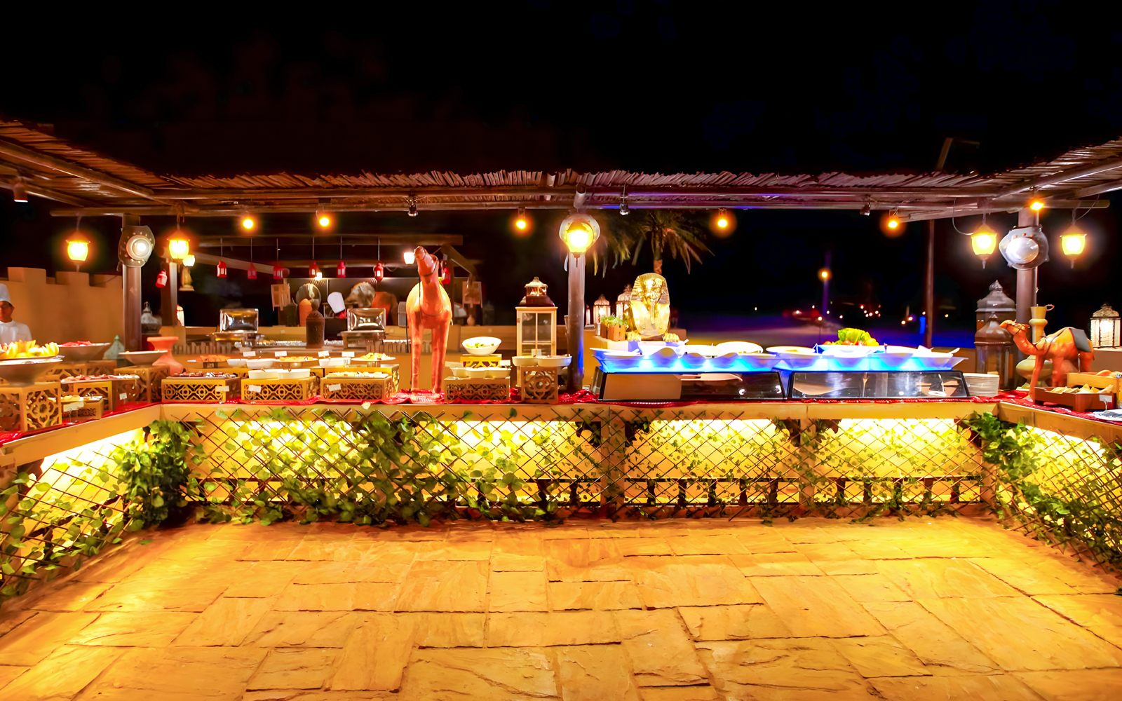 Buffet setup at a royal dining area in Dubai, featuring decorative elements and ambient lighting.