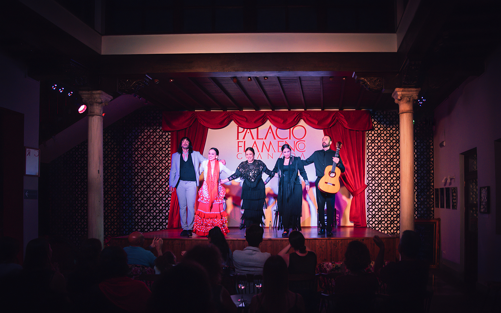 Performers on stage at Palacio Flamenco Granada show, with a guitarist and dancers.