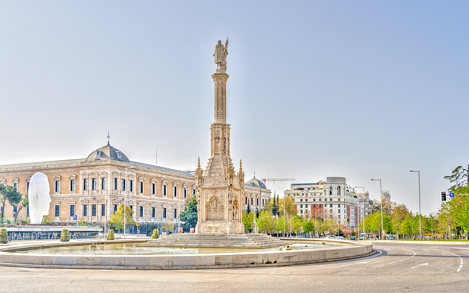 Columbus Monument in Plaza de Colón, Madrid, with surrounding buildings.