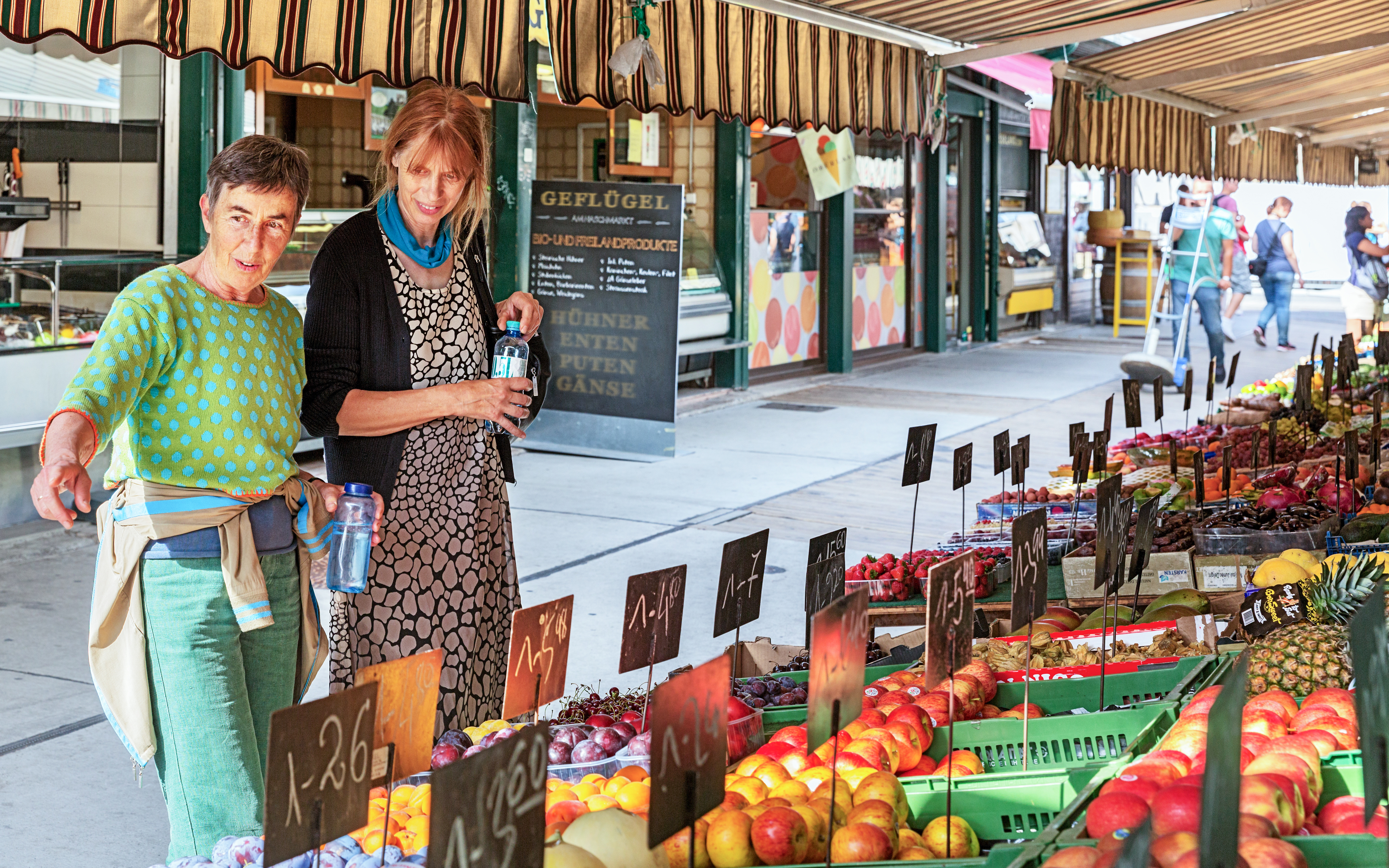 Tourist at Naschmarkt with vendor, Vienna