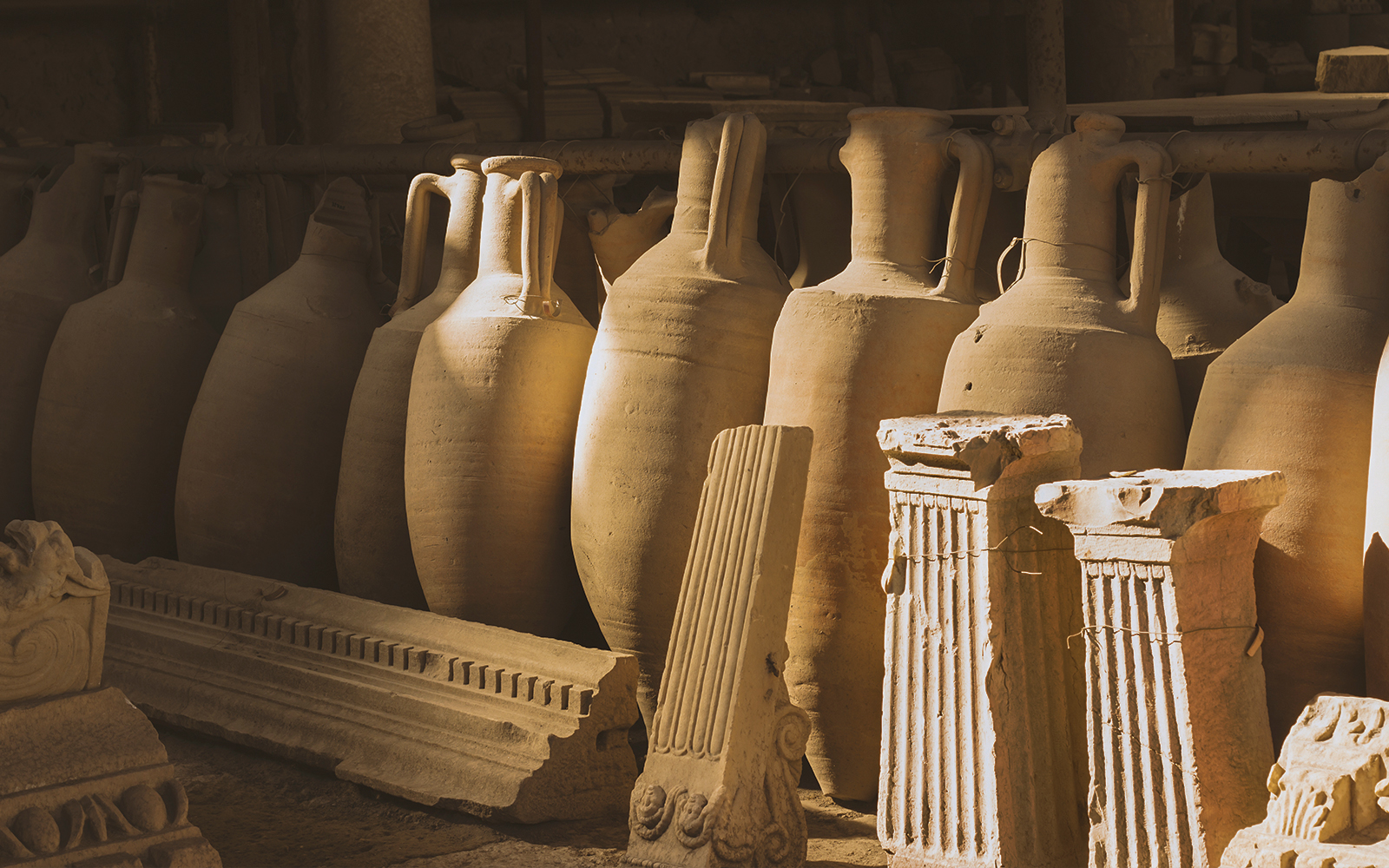 Ancient pottery and artifacts displayed in Naples ruins exhibit.