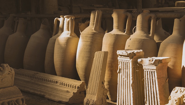 Ancient pottery and artifacts displayed in Naples ruins exhibit.