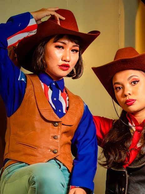Cowboys and cowgirls in western attire at Sunway Lagoon Night Park.