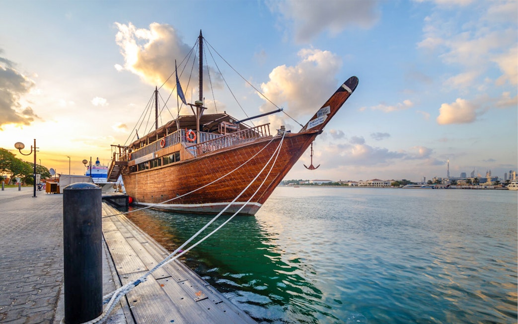Dhow boat docked at sunset in Dubai Creek, Dubai.