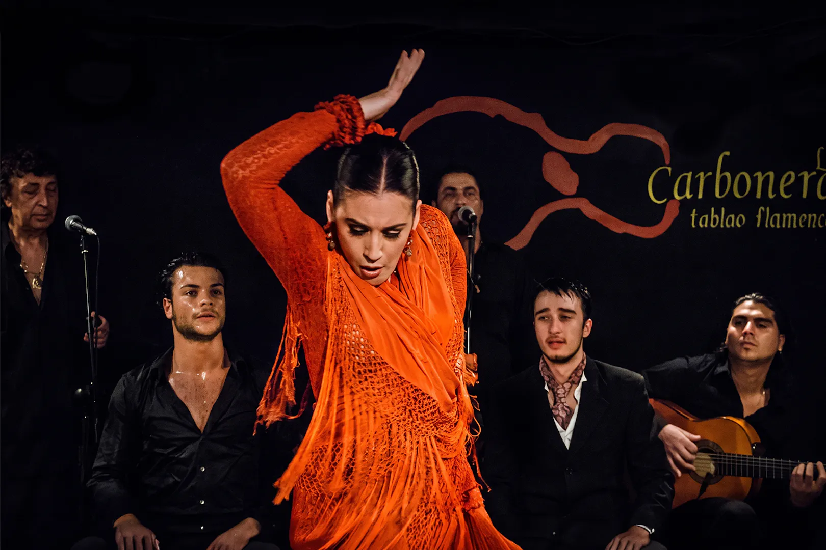 Flamenco dancer performing at Tablao LAS CARBONERAS with musicians in Madrid.