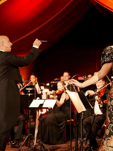 Conductor and singer performing at Strauss concert in Prater, Vienna.