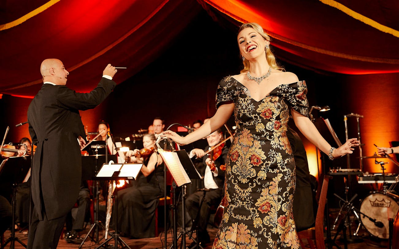 Conductor and singer performing at Strauss concert in Prater, Vienna.