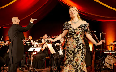 Conductor and singer performing at Strauss concert in Prater, Vienna.