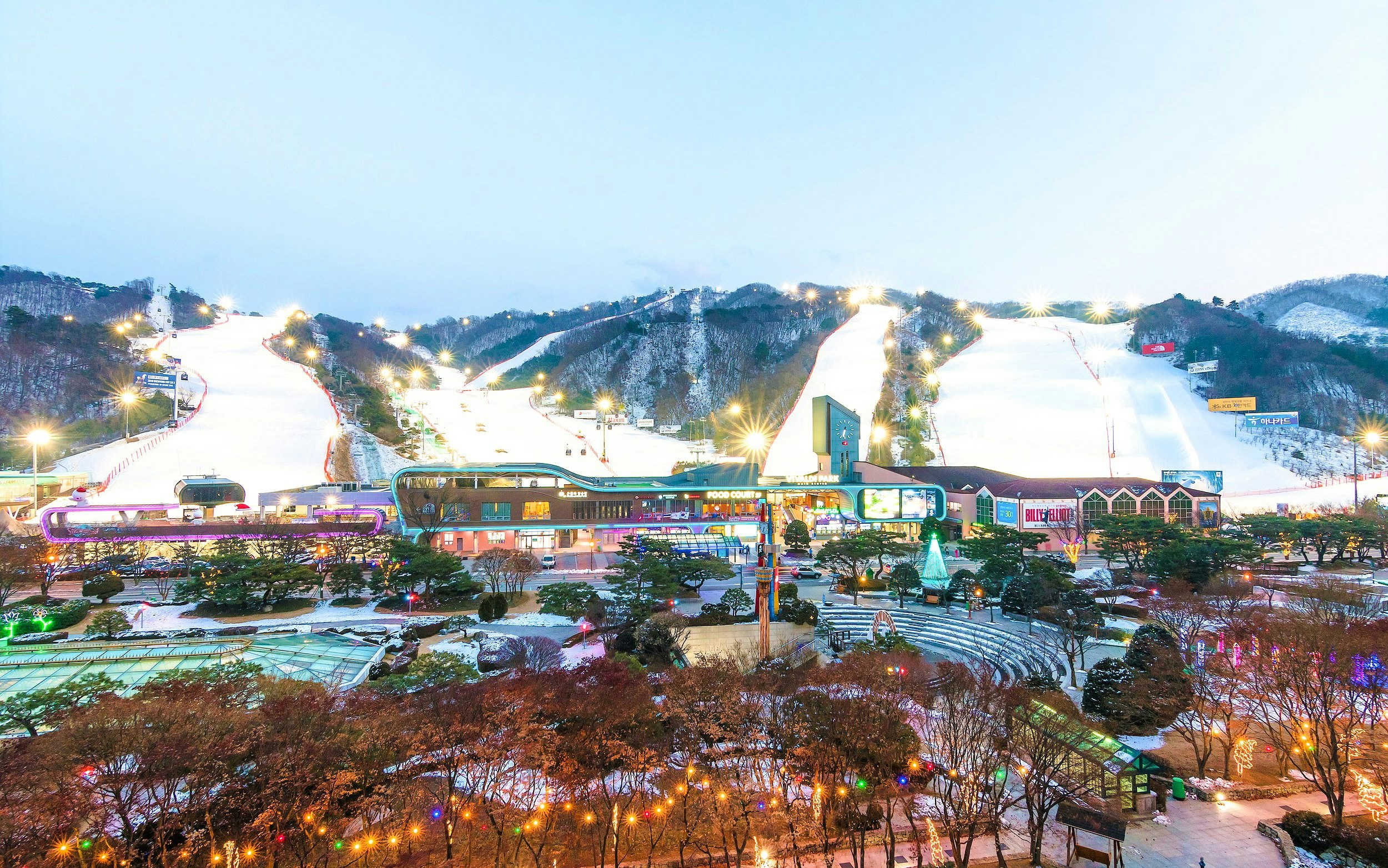 Vivaldi Park Ski World slopes and facilities illuminated at dusk.