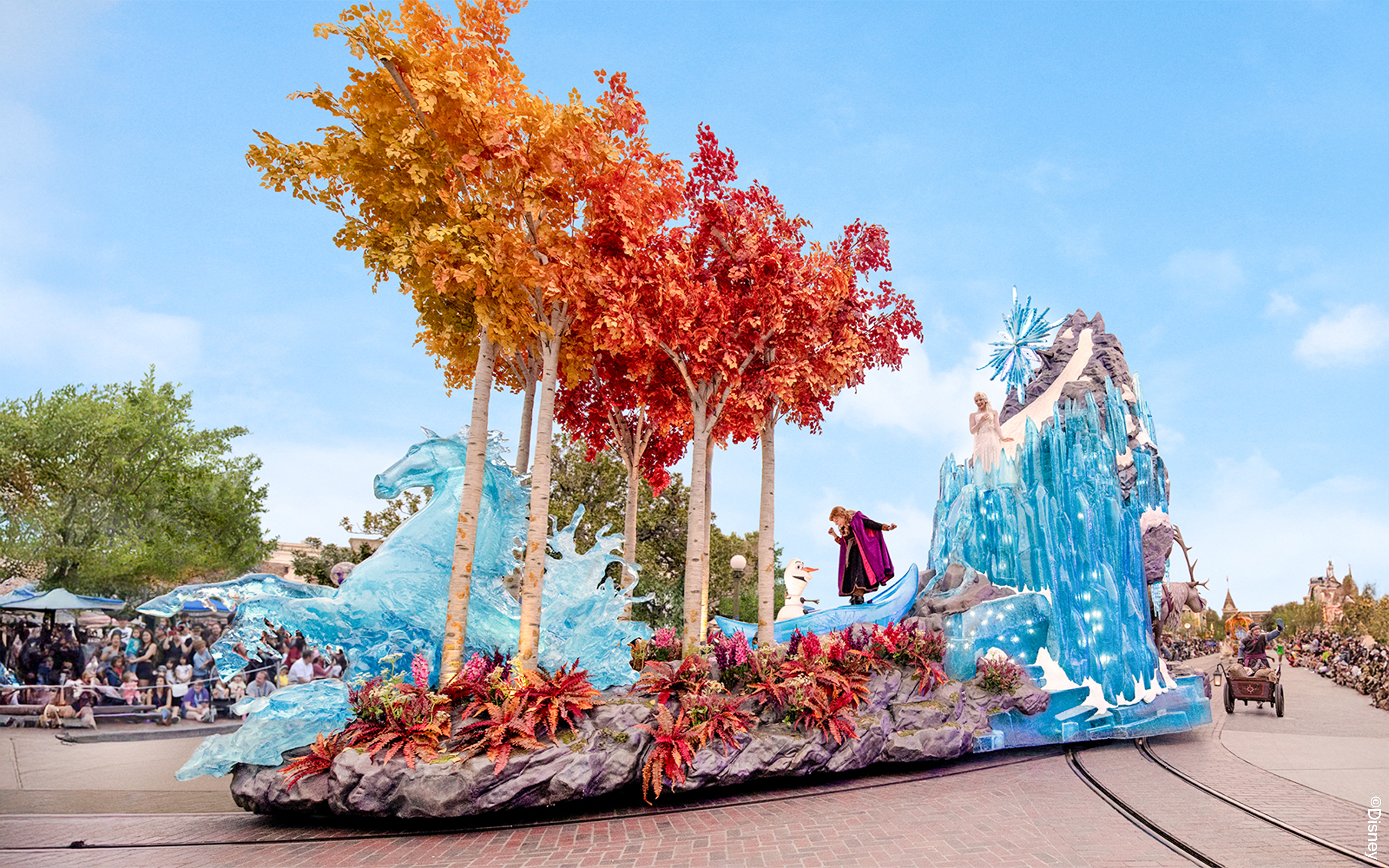 Disneyland Park parade float with Frozen characters and ice-themed decorations in California.