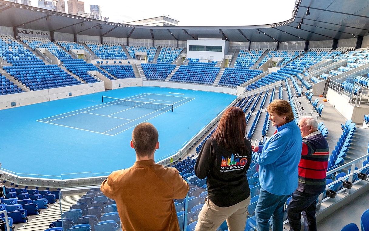 Visitors overlooking a tennis court at Melbourne's Kia Arena during a sports lovers day tour.