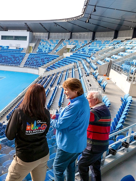 Visitors overlooking a tennis court at Melbourne's Kia Arena during a sports lovers day tour.