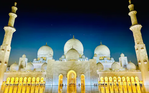 Sheikh Zayed Grand Mosque illuminated at night, Abu Dhabi city tour from Dubai.