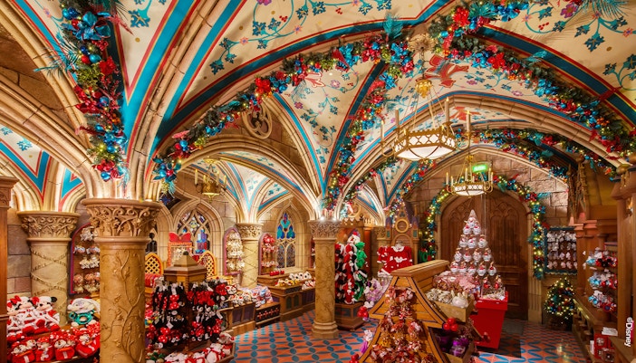 Disneyland Paris Christmas shop decorated with festive garlands and holiday merchandise.