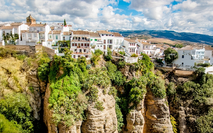 Cliffside houses in Ronda, Spain, perched on the edge of El Tajo gorge.