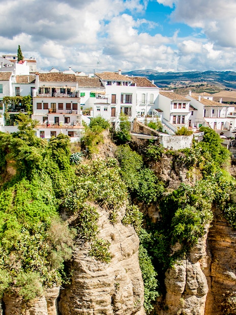 Cliffside houses in Ronda, Spain, perched on the edge of El Tajo gorge.