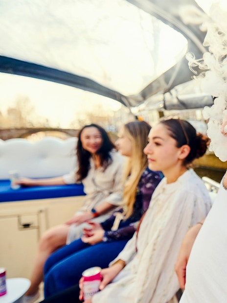 Guests enjoying the Cloud Boat Cruise with canal view.