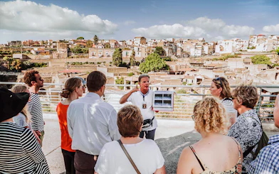 Guide explaining ruins to tour group at Herculaneum, Italy.