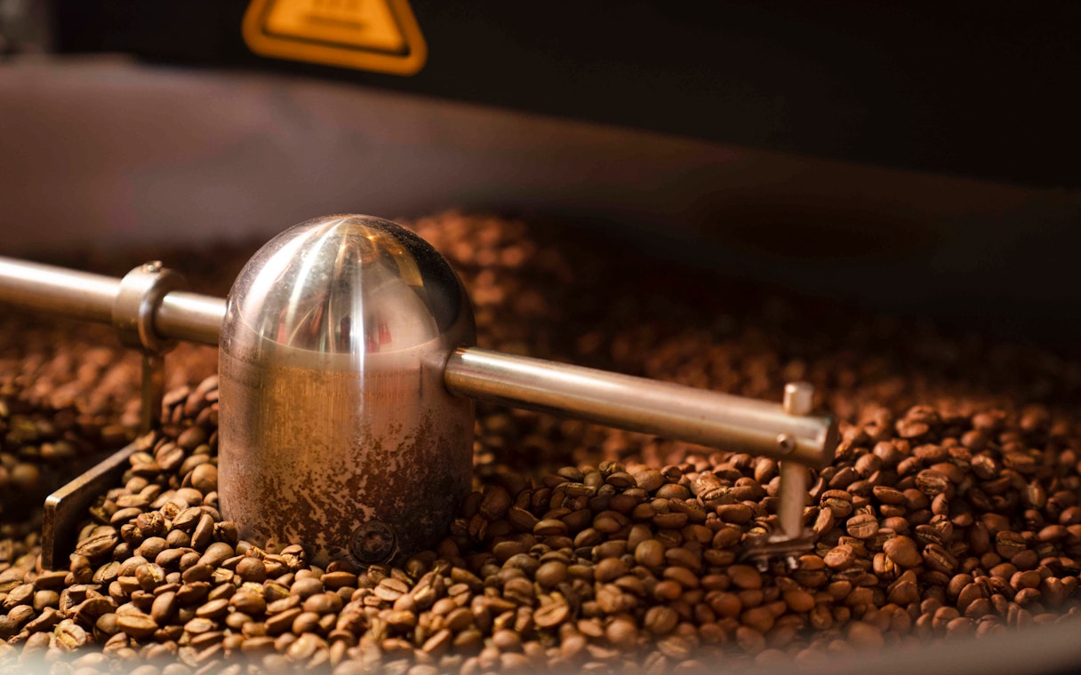 Coffee beans being ground in Chamarel, Mauritius.