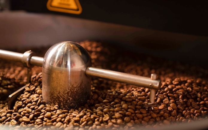 Coffee beans being ground in Chamarel, Mauritius.