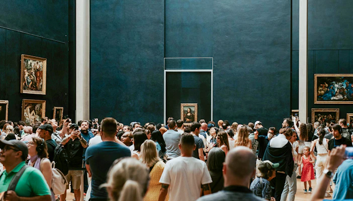 Crowd viewing the Mona Lisa at the Louvre Museum in Paris.