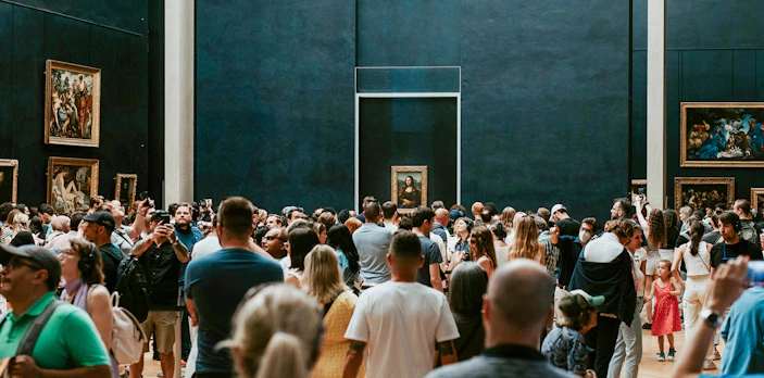 Crowd viewing the Mona Lisa at the Louvre Museum in Paris.