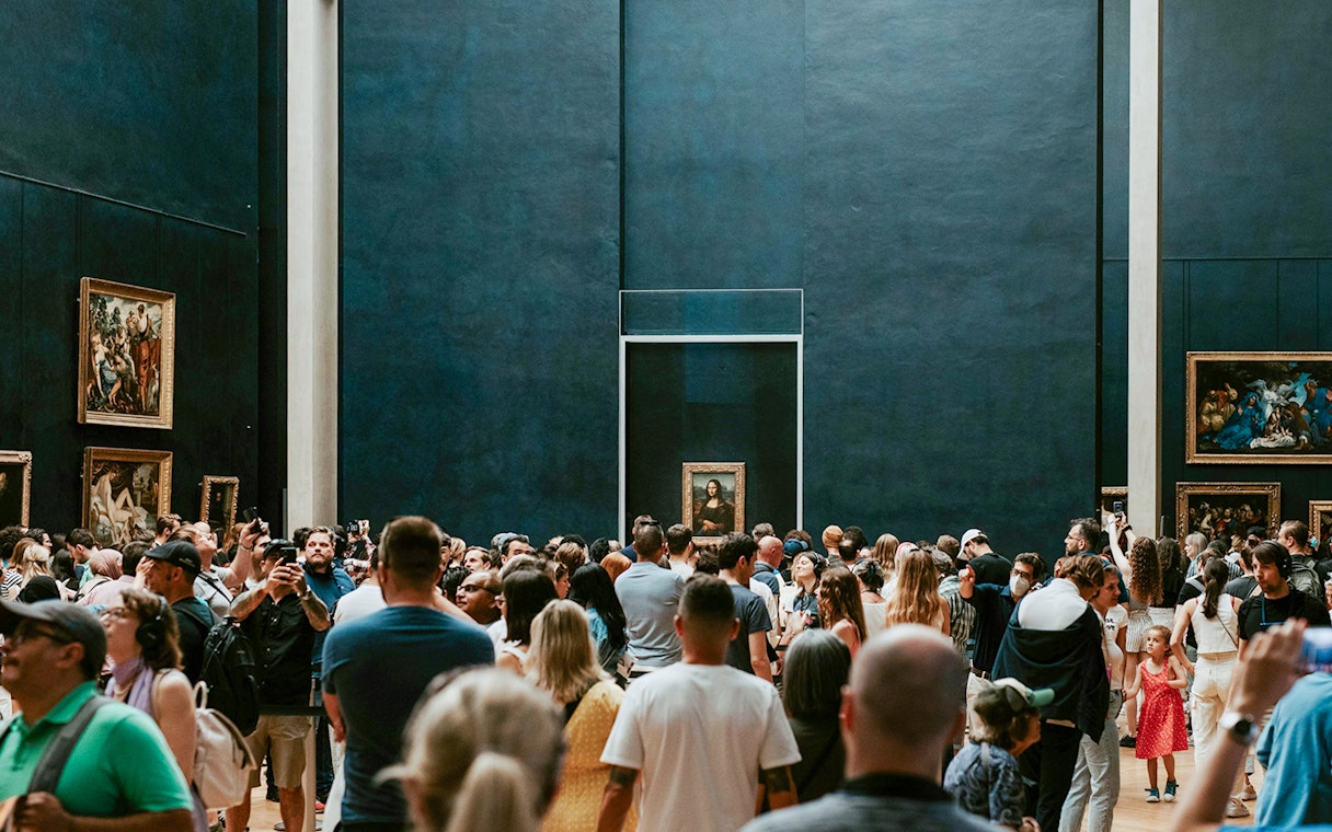 Crowd viewing the Mona Lisa at the Louvre Museum in Paris.