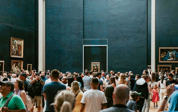 Crowd viewing the Mona Lisa at the Louvre Museum in Paris.