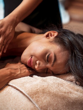 Person receiving a relaxing massage at a spa.