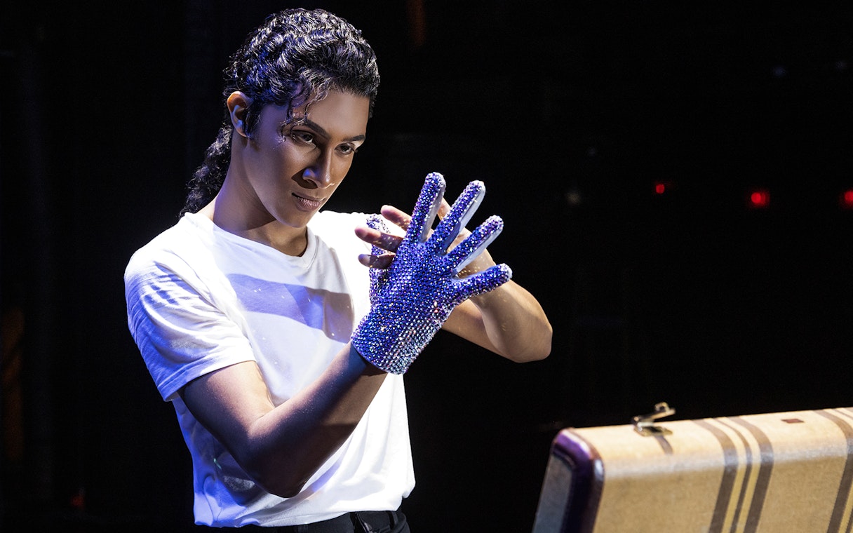 Performer wearing a sequined glove at MJ Live tribute concert.